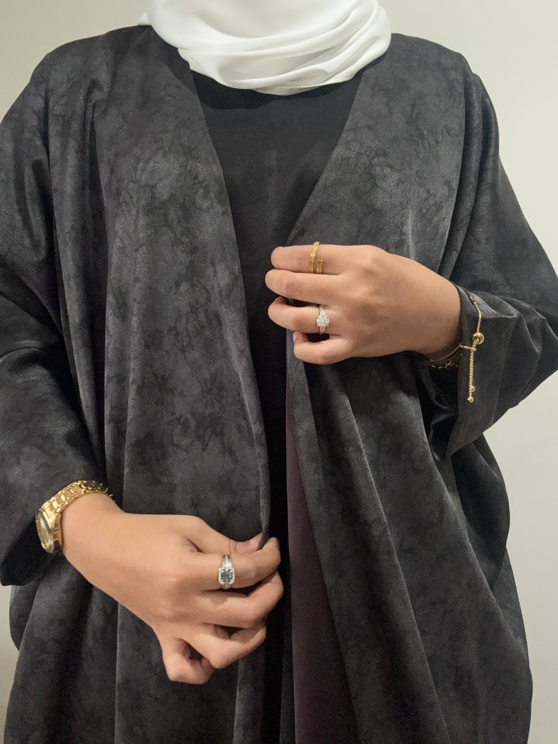 Luxury black abaya with a subtle shimmer, crafted from premium Saudi Nida fabric for a timeless modest look